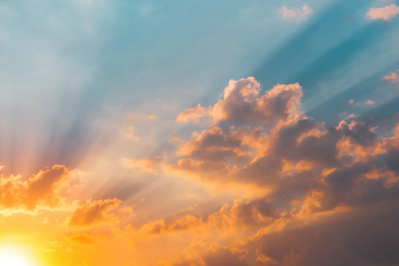 Sunbeams breaking through golden clouds