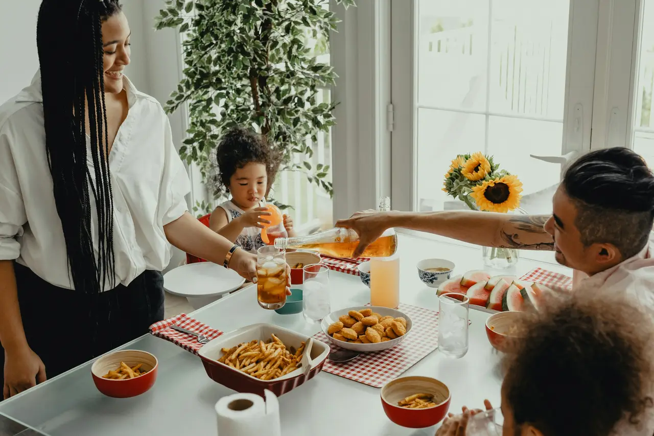 A family sharing breakfast together at a sunny kitchen table